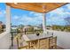 Balcony featuring a wood ceiling, a white railing, and ocean views at 135 Avenida Veneccia, Sarasota, FL 34242