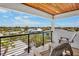 Expansive balcony features seating and scenic neighborhood views under a tongue and groove ceiling at 135 Avenida Veneccia, Sarasota, FL 34242