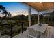 Covered balcony with a wood ceiling and views of the neighborhood and palm trees at 135 Avenida Veneccia, Sarasota, FL 34242