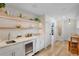 Chic bar area with open shelving, wine refrigerator, and convenient serving space at 135 Avenida Veneccia, Sarasota, FL 34242