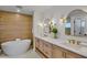 Spa-like bathroom with soaking tub, dual vanities, and modern gold fixtures at 135 Avenida Veneccia, Sarasota, FL 34242