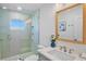 Modern bathroom features a glass shower, stylish mirror, and sleek fixtures at 135 Avenida Veneccia, Sarasota, FL 34242