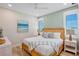 Calm bedroom featuring a wooden bed frame, matching nightstands, and soft blue accents at 135 Avenida Veneccia, Sarasota, FL 34242
