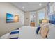 Bedroom with a mounted flat screen TV and a glimpse of the attached bathroom at 135 Avenida Veneccia, Sarasota, FL 34242