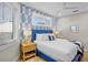 Bright bedroom with blue accents, including a patterned wallpaper and a comfortable blue bed frame at 135 Avenida Veneccia, Sarasota, FL 34242