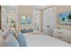 Inviting bedroom with neutral tones and a view into an adjacent bathroom, offering comfort and style at 135 Avenida Veneccia, Sarasota, FL 34242
