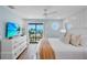 Light-filled bedroom with balcony access, coastal views, and elegant decor at 135 Avenida Veneccia, Sarasota, FL 34242