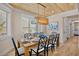Elegant dining room with a light-wood table and decoratively draped lighting, perfect for Gathering gatherings at 135 Avenida Veneccia, Sarasota, FL 34242