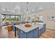 Gourmet kitchen with a large island, prep sink, marble countertops, and an open floor plan at 135 Avenida Veneccia, Sarasota, FL 34242