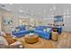 Open-concept living room with a comfortable sectional sofa and views into the dining area and kitchen at 135 Avenida Veneccia, Sarasota, FL 34242