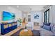 Comfortable living room features a coastal theme, a TV, an elevator and stairs at 135 Avenida Veneccia, Sarasota, FL 34242