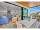 Open living area with a blue couch and dining table leading to a modern kitchen at 135 Avenida Veneccia, Sarasota, FL 34242