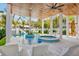 Beautiful pool area featuring a spa, water features, and covered seating at 135 Avenida Veneccia, Sarasota, FL 34242