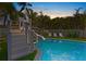 Private pool area features a slide, sun loungers, and lush landscaping at 135 Avenida Veneccia, Sarasota, FL 34242