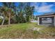 Large back yard with palm trees and a screened in porch at 1370 Mccrory St, North Port, FL 34286