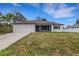 Charming single-story home with a two-car garage and a well-maintained front lawn at 1370 Mccrory St, North Port, FL 34286