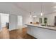 Open-concept kitchen with granite countertops, a center island, and a seamless transition to the dining space at 1370 Mccrory St, North Port, FL 34286
