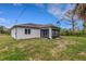 Rear exterior view of home with screened lanai and grassy yard at 1370 Mccrory St, North Port, FL 34286