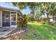 A lush green lawn, vibrant plants, and landscaping accentuate the backyard at 1516 Red Oak Ln, Port Charlotte, FL 33948