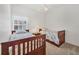 Bedroom with two beds, neutral carpet, and a window dressed with decorative lace at 1516 Red Oak Ln, Port Charlotte, FL 33948