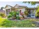 Charming home exterior featuring a well-maintained lawn and vibrant landscaping at 1516 Red Oak Ln, Port Charlotte, FL 33948