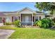 Charming single-story home with a well-maintained lawn, complemented by vibrant greenery and a cozy, covered entryway at 1516 Red Oak Ln, Port Charlotte, FL 33948
