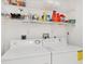 Well-organized laundry room with ample storage shelves and an energy efficient washer and dryer at 1516 Red Oak Ln, Port Charlotte, FL 33948