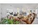 Bright living room with tile floors, a ceiling fan, and patio doors leading to the screened-in patio at 1516 Red Oak Ln, Port Charlotte, FL 33948