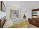 Bright main bedroom features a ceiling fan and a decorative bedspread at 1516 Red Oak Ln, Port Charlotte, FL 33948