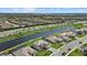 Aerial shot shows community pond with houses, many with pools and screen enclosures at 15315 Golden Beam Pl, Bradenton, FL 34211