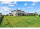 A backyard shows a spacious lawn, screened in porch and an enclosed pool at 15315 Golden Beam Pl, Bradenton, FL 34211