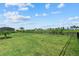A large backyard with lush green grass and a view of a pond at 15315 Golden Beam Pl, Bradenton, FL 34211
