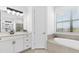 Well-lit bathroom featuring a soaking tub, glass shower, and modern vanity at 15315 Golden Beam Pl, Bradenton, FL 34211