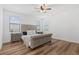 Bedroom features hardwood floors, neutral walls, and a tufted headboard bed at 15315 Golden Beam Pl, Bradenton, FL 34211
