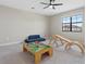 A playroom/bedroom has a table, toy train, and play slide on soft carpet at 15315 Golden Beam Pl, Bradenton, FL 34211
