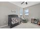 A modern bedroom features a crib, beanbag chair, and ample natural light at 15315 Golden Beam Pl, Bradenton, FL 34211
