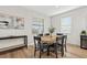 Charming dining room features wood floors, modern lighting, neutral paint, and a view from two windows, enhancing the space's appeal at 15315 Golden Beam Pl, Bradenton, FL 34211