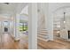 Welcoming entryway with hardwood floors, white columns, and staircase, leading to the living room at 15315 Golden Beam Pl, Bradenton, FL 34211