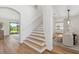Bright entryway with wooden floors, staircase, and views to dining and living spaces at 15315 Golden Beam Pl, Bradenton, FL 34211
