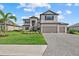 Charming two-story home boasts a three-car garage and a paved driveway at 15315 Golden Beam Pl, Bradenton, FL 34211