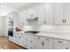 Modern kitchen with white cabinetry, stainless steel appliances, and quartz countertops at 15315 Golden Beam Pl, Bradenton, FL 34211