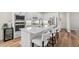 Modern kitchen with stainless steel appliances, white cabinets, a large center island, and stylish bar stools for seating at 15315 Golden Beam Pl, Bradenton, FL 34211