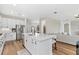 Contemporary kitchen featuring a spacious island, stainless steel appliances, sleek cabinetry, and an open layout to the living area at 15315 Golden Beam Pl, Bradenton, FL 34211