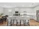 Bright kitchen features a large island with bar seating, stainless steel appliances, and hardwood floors at 15315 Golden Beam Pl, Bradenton, FL 34211