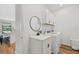 Well-lit laundry room with a sink, mirror, and cabinetry above the washer and dryer at 15315 Golden Beam Pl, Bradenton, FL 34211