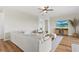 Spacious living room features an open floor plan, wood flooring, a ceiling fan, and a comfortable sofa, creating a welcoming space at 15315 Golden Beam Pl, Bradenton, FL 34211