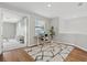 Bright office/loft area boasts wood floors, a patterned rug, and lots of light at 15315 Golden Beam Pl, Bradenton, FL 34211