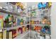 Organized walk-in pantry featuring wire shelving, clear storage bins, and ample space for food and household storage solutions at 15315 Golden Beam Pl, Bradenton, FL 34211