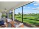 Relaxing screened patio offers beautiful views of the lush lawn and serene lake beyond at 15315 Golden Beam Pl, Bradenton, FL 34211