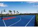 Bright blue basketball court provides a recreational area with hoops and clear markings at 15607 White Linen Dr, Bradenton, FL 34211